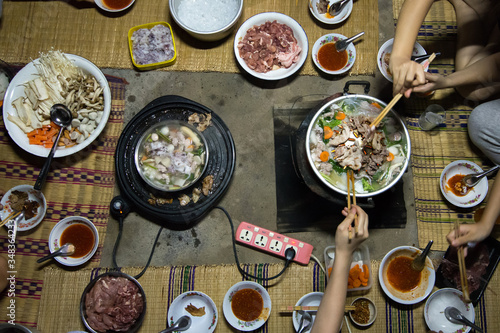Top view of family enjoy eating Shabu and Brabecue together.