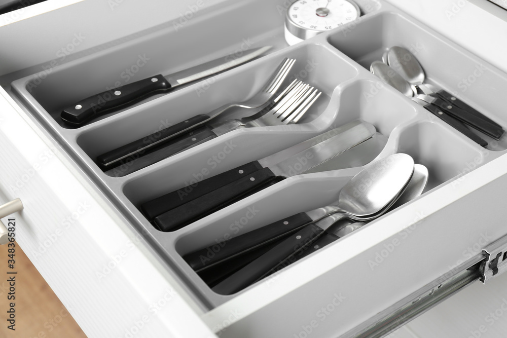 Open drawer with different utensils. Order in kitchen Open drawer with different utensils. Order in kitchen