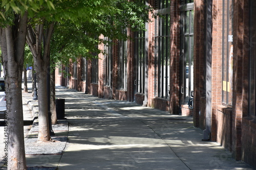 Shaded sidewalk and urban landscape of the city photo