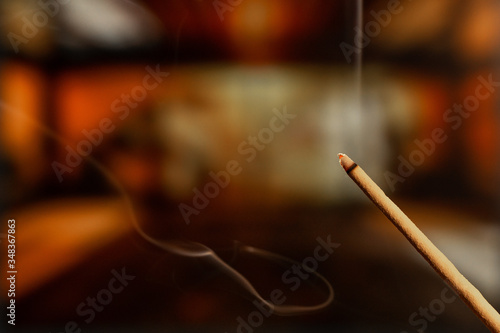 Burning Incense Sticks with smoke, joss sticks burning at a vintage Buddhist temple © Anthony Paz