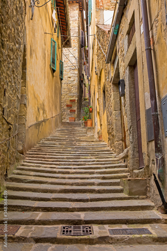 Narrow, cobblestone alley in Cortona, a hill town in the Tuscany region of Italy