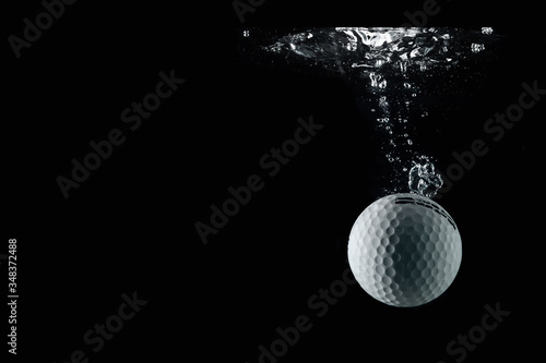 golf ball entering the water and splashing
