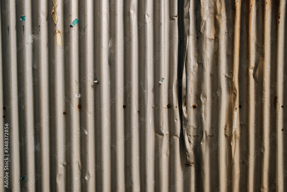 Old brown wavy metal plate wall texture background