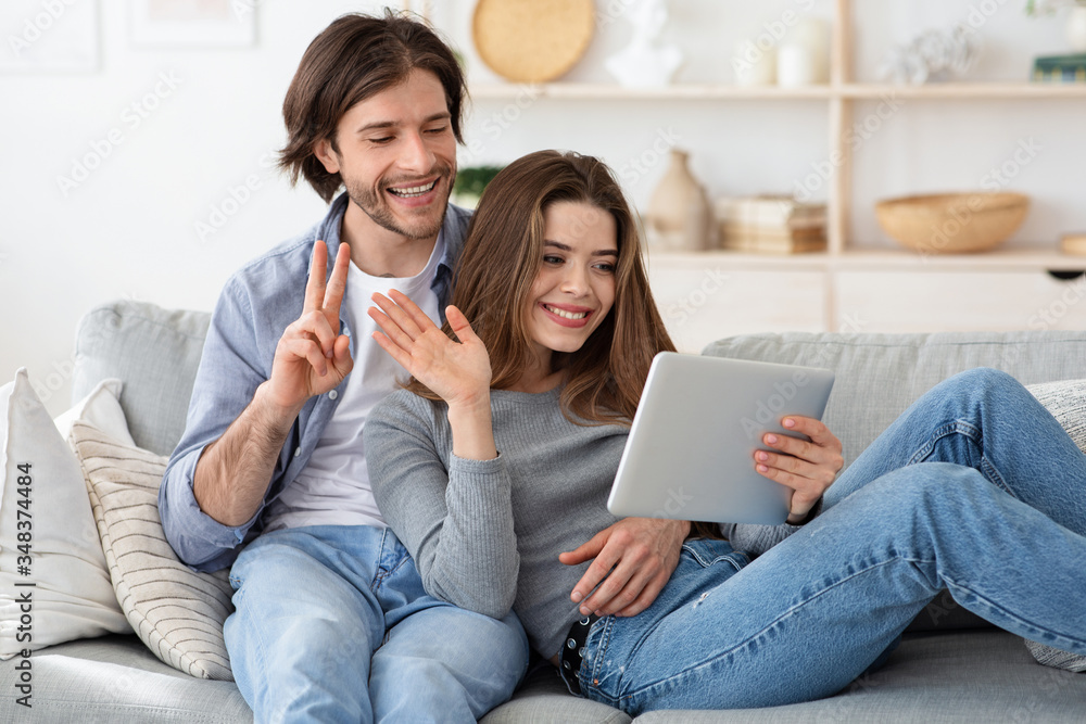 Man and woman having video conference, using tablet at home Man and woman having video conference, using tablet at home
