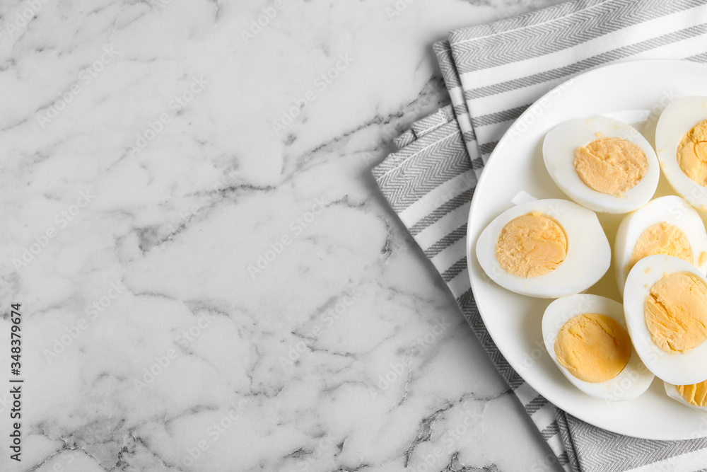 Tasty hard boiled eggs on white marble table, flat lay. Space for text Tasty hard boiled eggs on white marble table, flat lay. Space for text