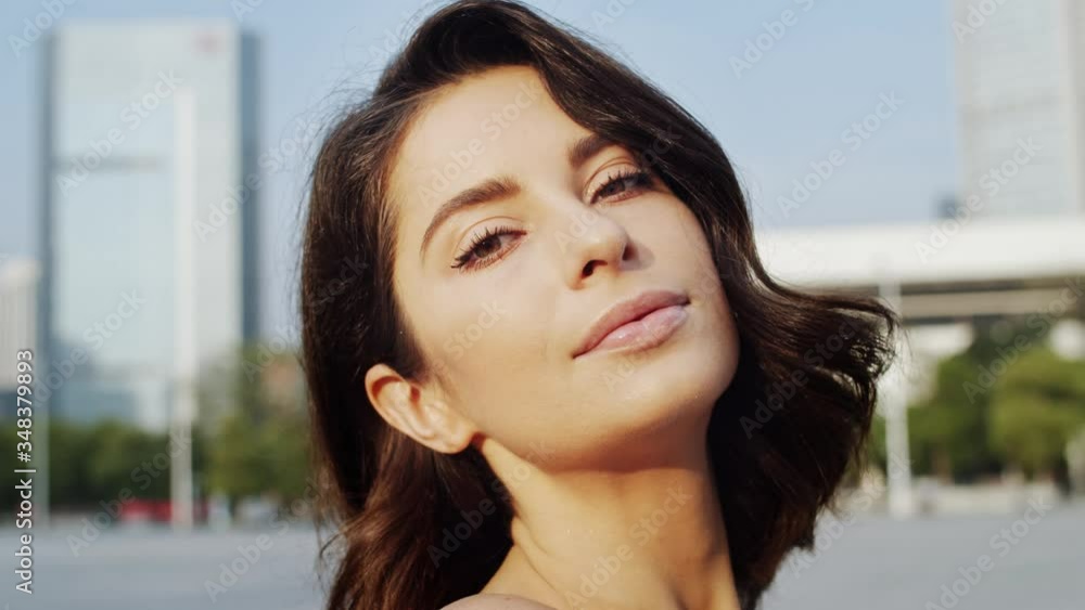 Close up portrait of attractive brunette woman posing in outdoor city square in early morning. Close up portrait of attractive brunette woman posing in outdoor city square in early morning.