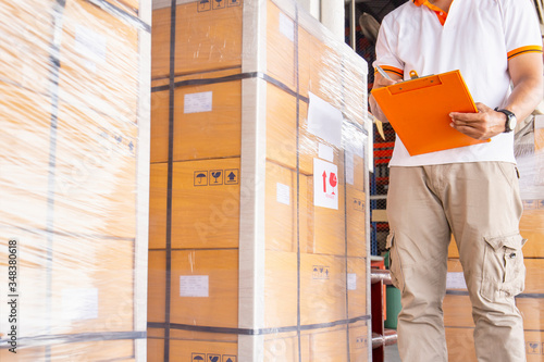 warehouse inventory management, worker hand holding clipboard and large pallet shipment in storage warehouse, business warehouse cargo and logistics