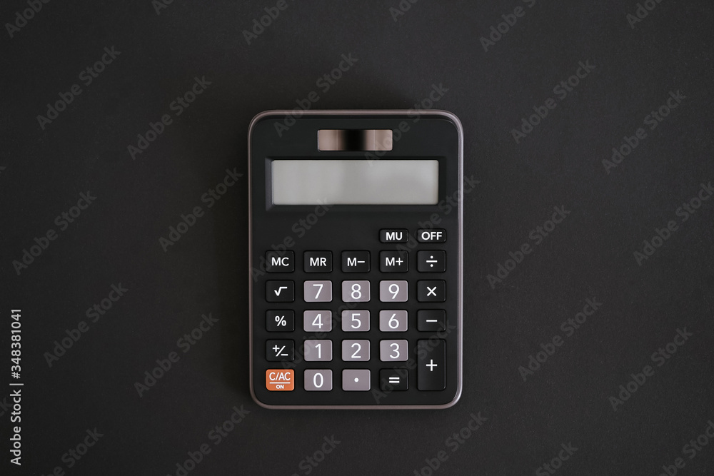Сalculator in the middle of the black background. Сalculator in the middle of the black background.
