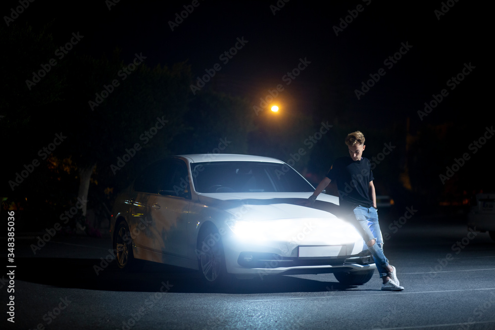 a guy near a modern electric car