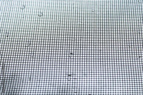 Mosquito net vokon frame with raindrops. 