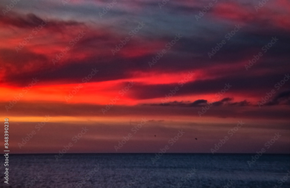 sunset over the sea, red, sky, ocean, clouds, water, beach, cloudscape, horizon, evening, beautiful, intense, dramatic