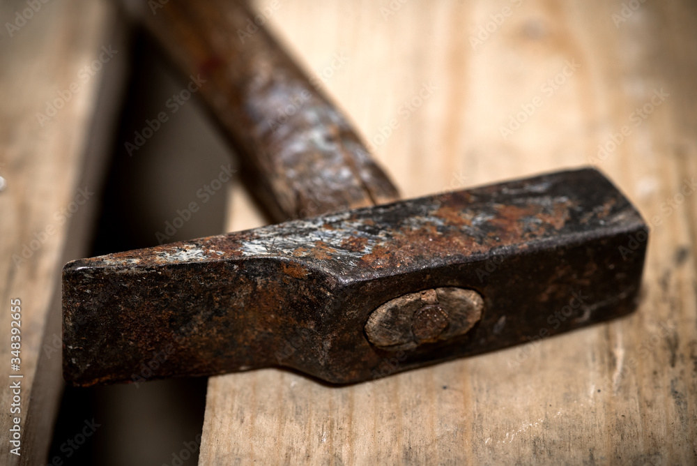 heavily used metal and wood hammer on top of a wooden pallet heavily used metal and wood hammer on top of a wooden pallet
