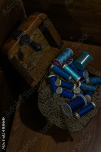 Wooden box with blue threads on a cloth
