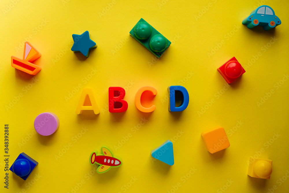 children's letters abcd on a yellow background top view children's letters abcd on a yellow background top view