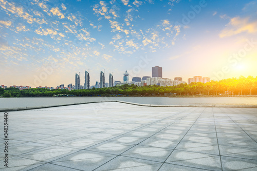 Fototapeta Naklejka Na Ścianę i Meble -  Empty square floor and city skyline with buildings in shanghai at sunset,China.