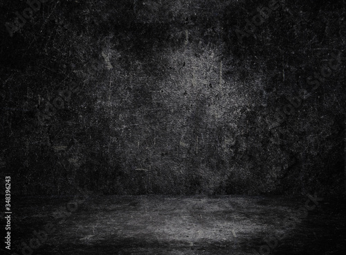 Empty space of Studio dark room black concrete grunge wall with concrete floor.
