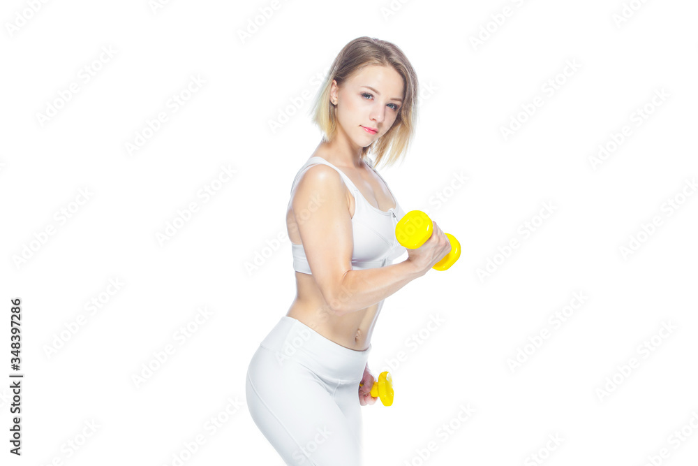 Fitness woman working out with yellow dumbbells showing her muscles on white background Fitness woman working out with yellow dumbbells showing her muscles on white background