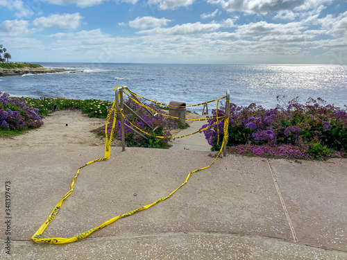 CClosed beach of La Jolla with informative signage during COVID-19 pandemic. Coronavirus virus panic and quarantine San Diego  USA  April 18th  2020