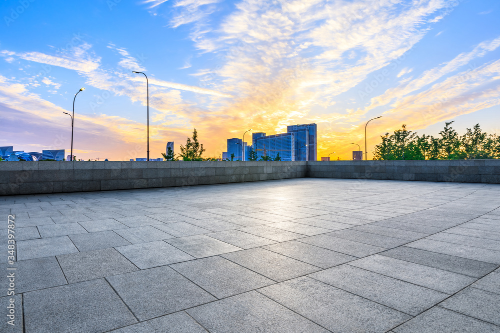 Empty square floor and city skyline with buildings in hangzhou at sunrise,China.