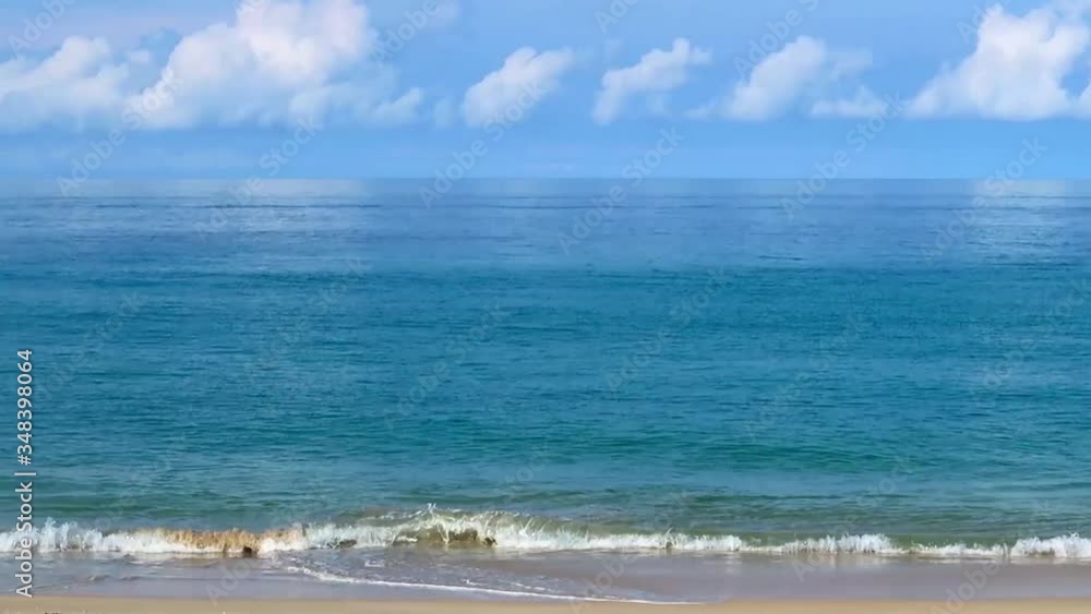 Slow Motion of Beautiful deep blue sea & calm ocean water with white soft waves reaching tropical sandy beach in nice warm weather on Sunny clear sky with puffy fluffy cloud & cloudscape, cinemagraphs Slow Motion of Beautiful deep blue sea & calm ocean water with white soft waves reaching tropical sandy beach in nice warm weather on Sunny clear sky with puffy fluffy cloud & cloudscape, cinemagraphs