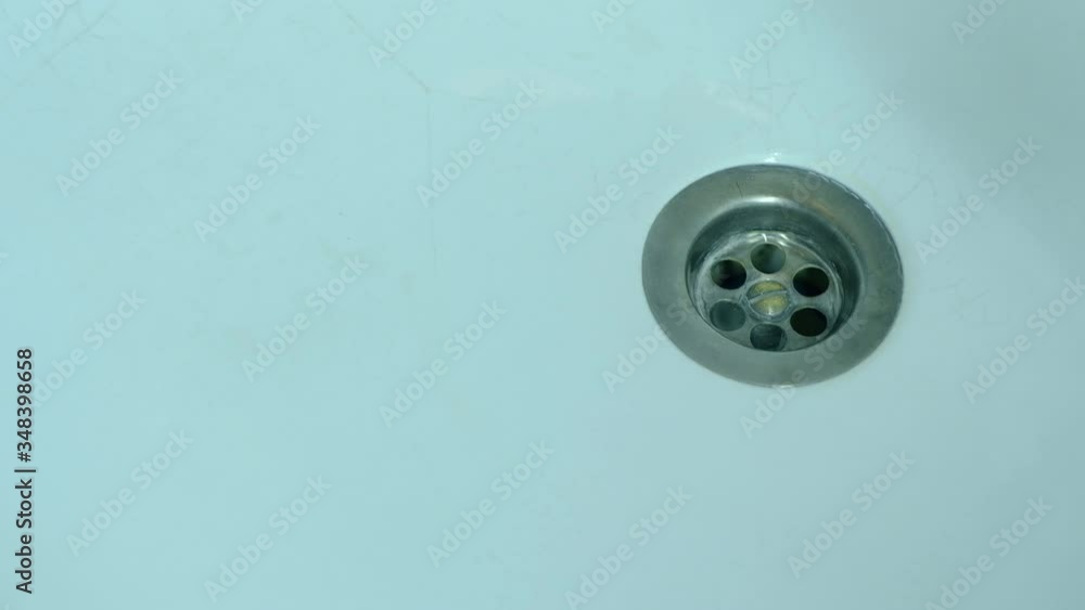 Dark blood flows intensively into the washbasin Dark blood flows intensively into the washbasin