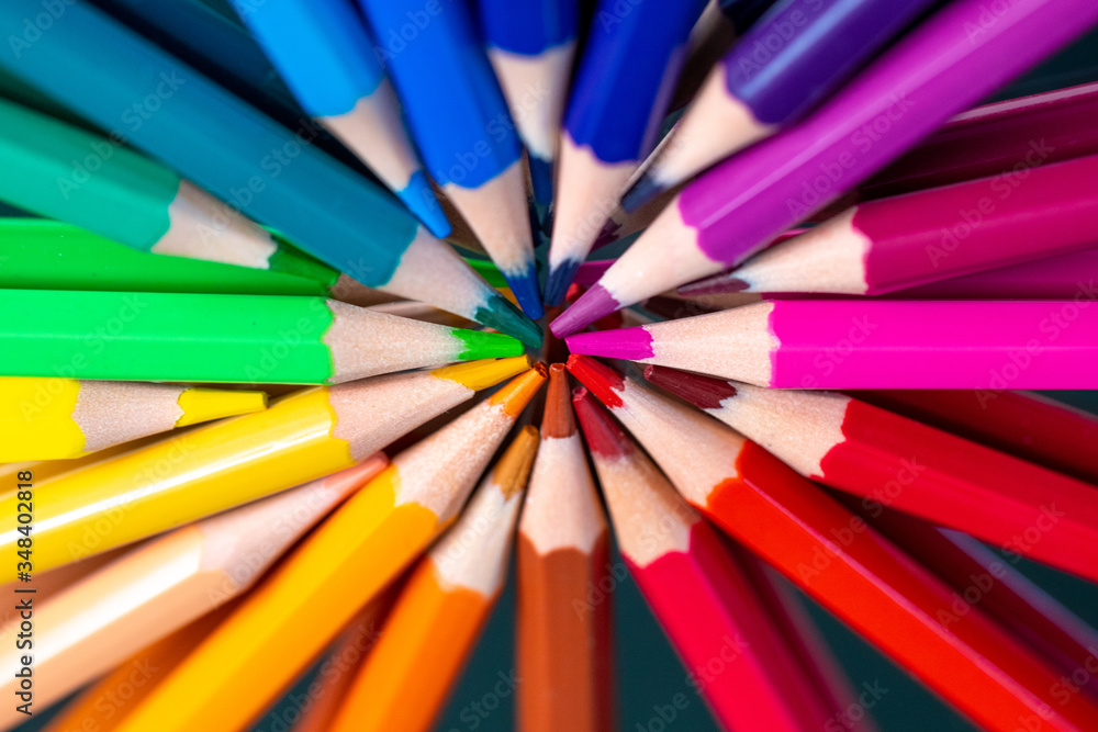 Many different colored pencils reflected on black Many different colored pencils reflected on black
