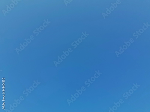 Natural blue texture and light white clouds, on a sunny day to a clear sky view of summer light, conceptual blurred background, with a soft gradient.
