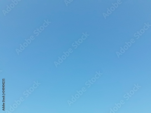 Natural blue texture and light white clouds, on a sunny day to a clear sky view of summer light, conceptual blurred background, with a soft gradient.