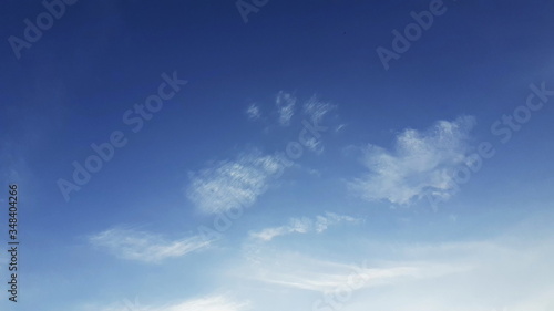 Photograph surface of a sparkling blue sky, with clean white clouds, and different shape sizes, a beautiful sky in the afternoon for summer, according to concept on blue background in air.