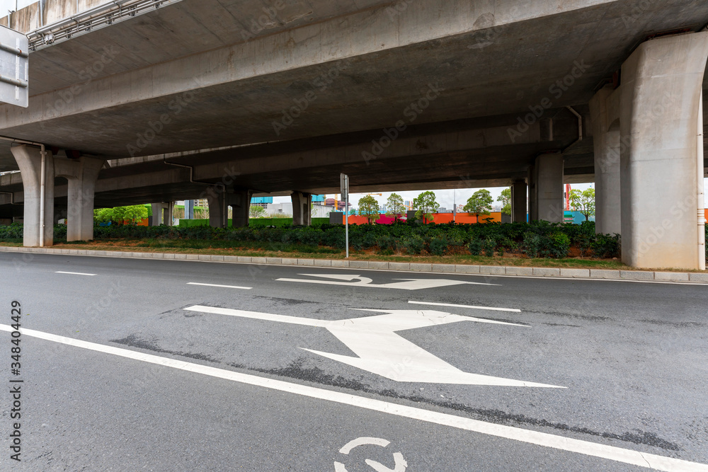 Concrete structure and asphalt road space under the overpass in the city Concrete structure and asphalt road space under the overpass in the city