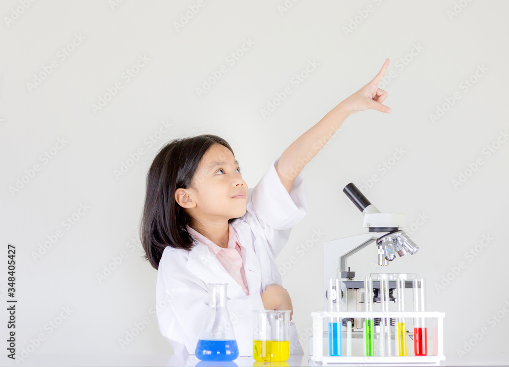 Children science concept, Happy little girl playing doing chemical experiments at the laboratory Children science concept, Happy little girl playing doing chemical experiments at the laboratory