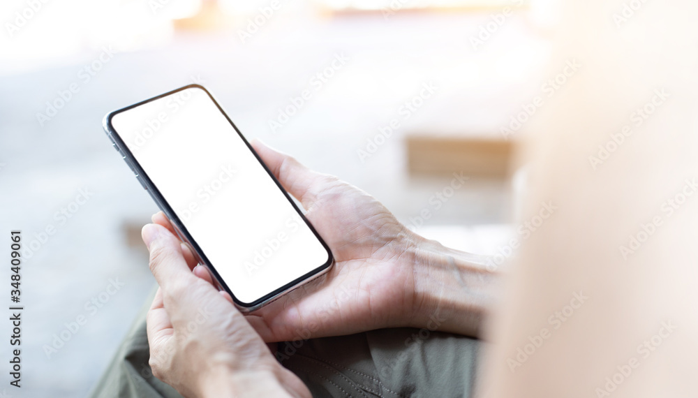 soft focus.cell phone Mockup blank white screen.woman hand holding texting using mobile sitting at outdoor.empty space for advertise.work people contact marketing business,technology