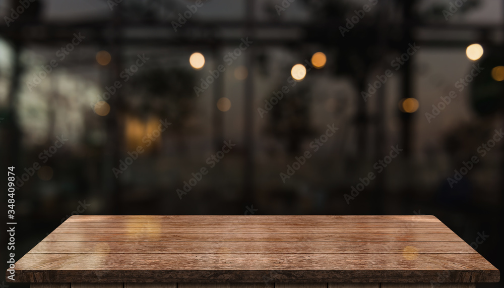 Empty old wood table top with bokeh coffee shop interior background.