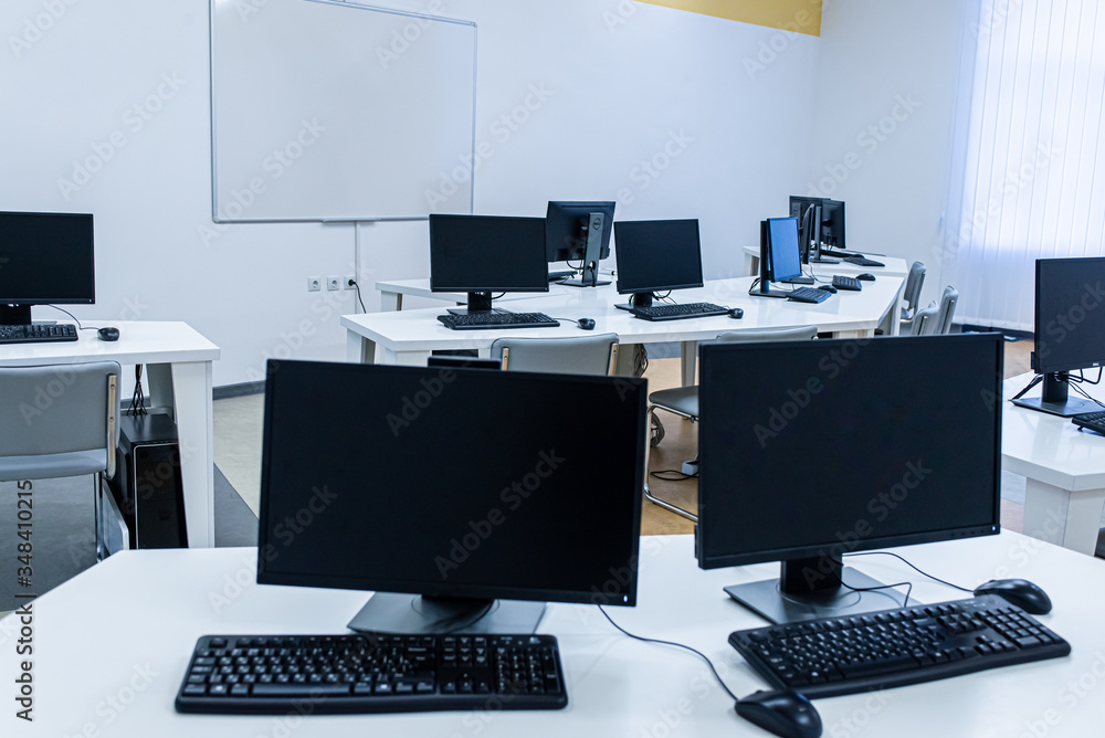 office room with computer tables with keyboard and mouse with a board and a projector office room with computer tables with keyboard and mouse with a board and a projector