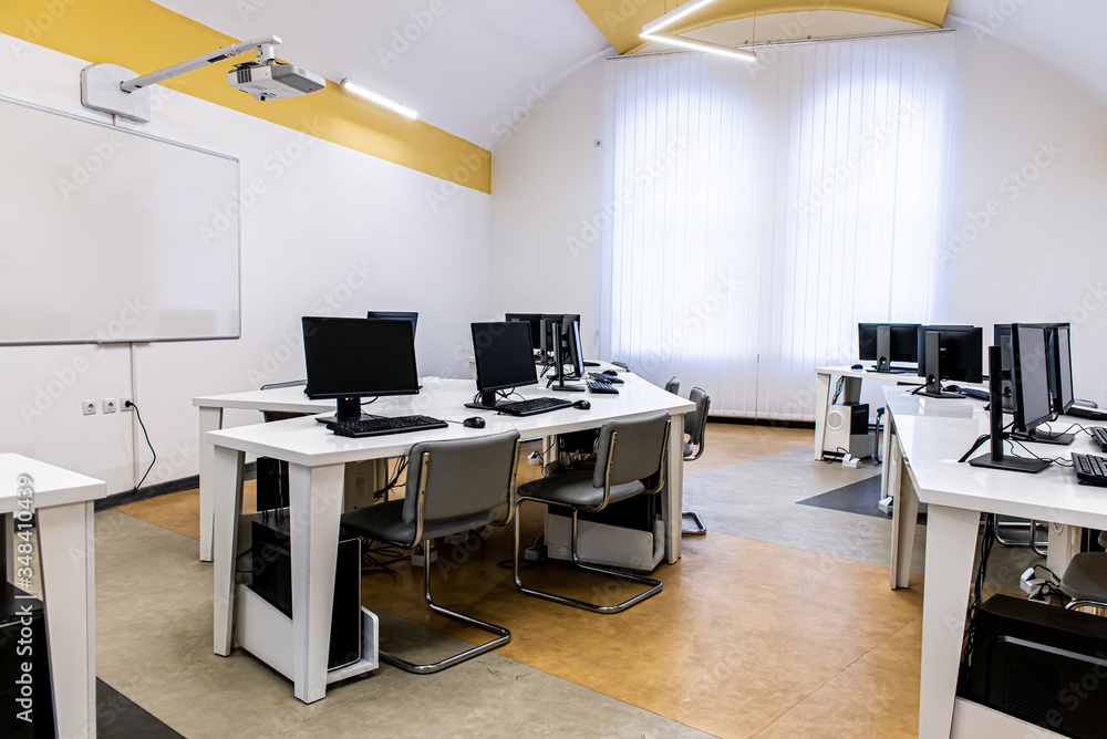 office room with computer tables with keyboard and mouse with a board and a projector office room with computer tables with keyboard and mouse with a board and a projector