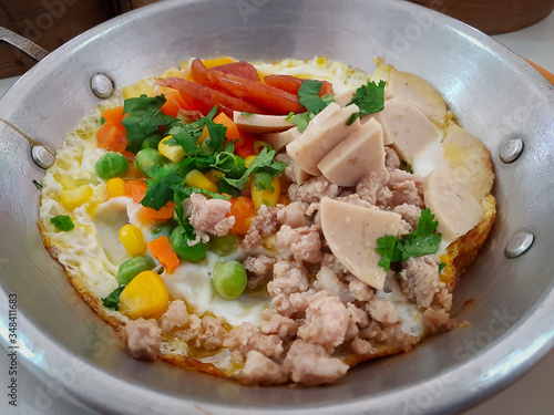 Menu egg pan with ingredients of fried egg, pork and vegetables. Breakfast of Southern Thailand.
