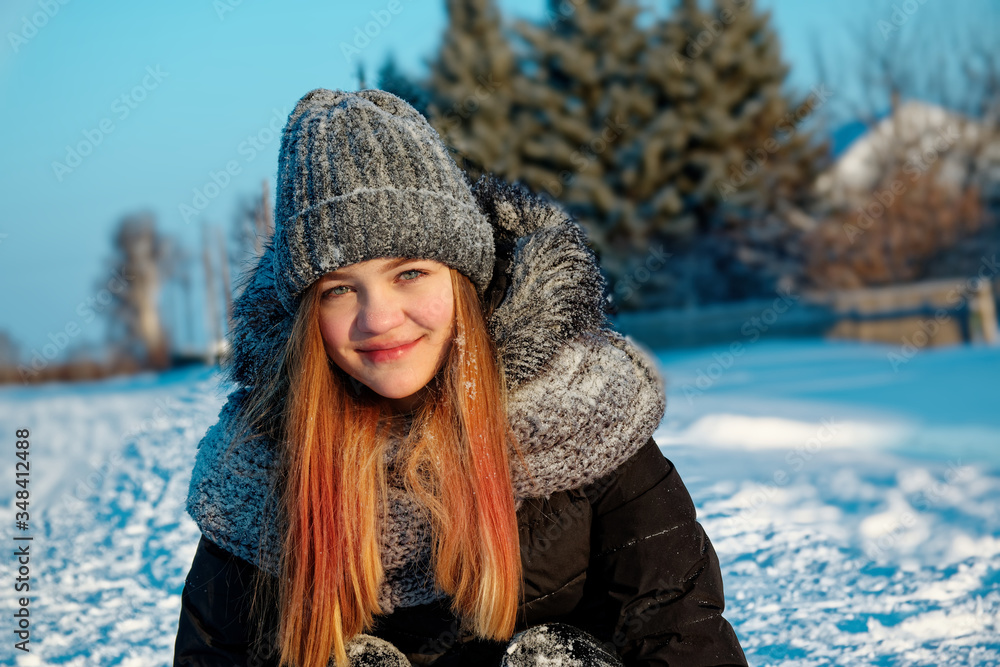 White beautiful young girl in winter clothes on the street. White beautiful young girl in winter clothes on the street.
