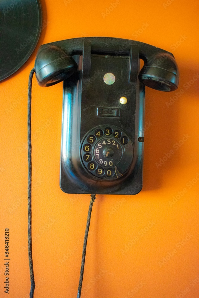 old fashioned rotary telephone on a wall old fashioned rotary telephone on a wall