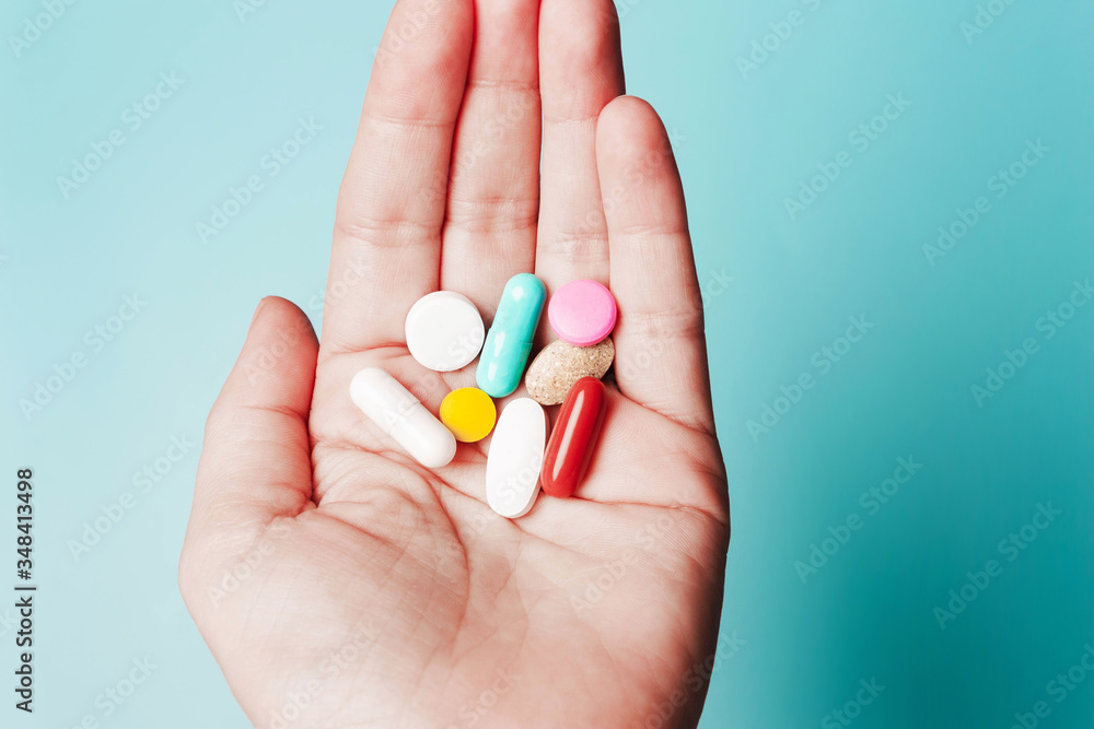 Pills in hand . The concept of health, treatment, disease Pills in hand . The concept of health, treatment, disease