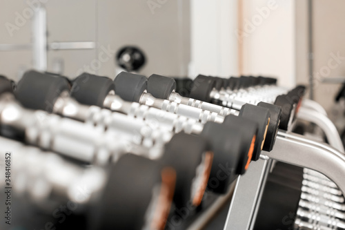 Dumbbells on stand in modern gym