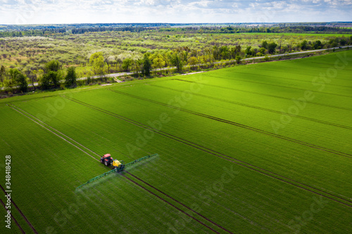 Farmland in Europe, tractor spraying pesticides photo