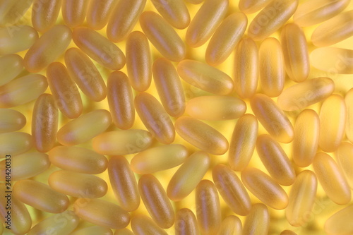 Omega 3 pills. Yellow background with pillows