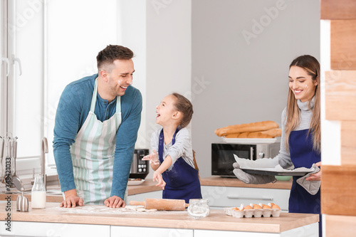 Happy family preparing cook...