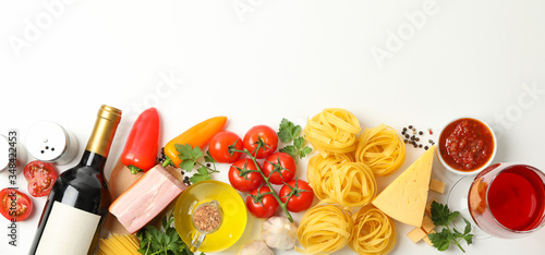 Composition with pasta and ingredients for cooking on white background  top view