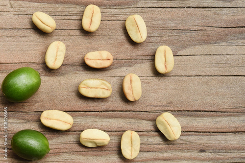 close up of fresh coffee beans on wooden background                                