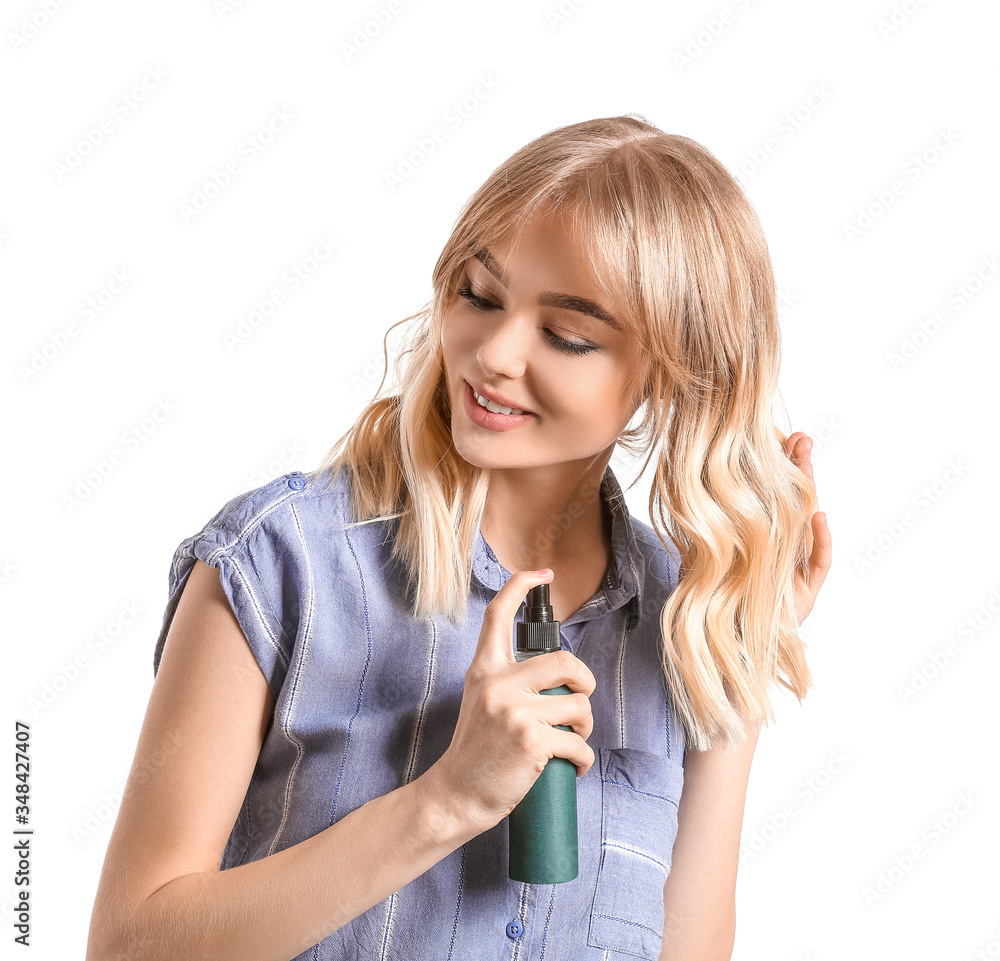 Beautiful young woman with hair spray on white background Beautiful young woman with hair spray on white background