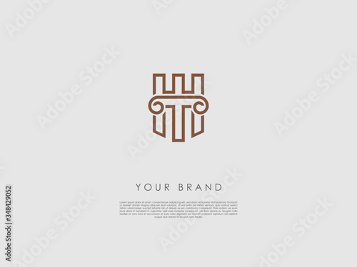 a bronze business logo that have an ancient column, letter t and h and a piece of a wall of a castle at the background