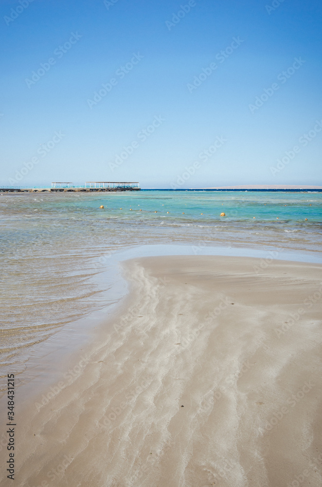 view of a beach and sea shore in summer day/Empty summer beach, with sunny sky