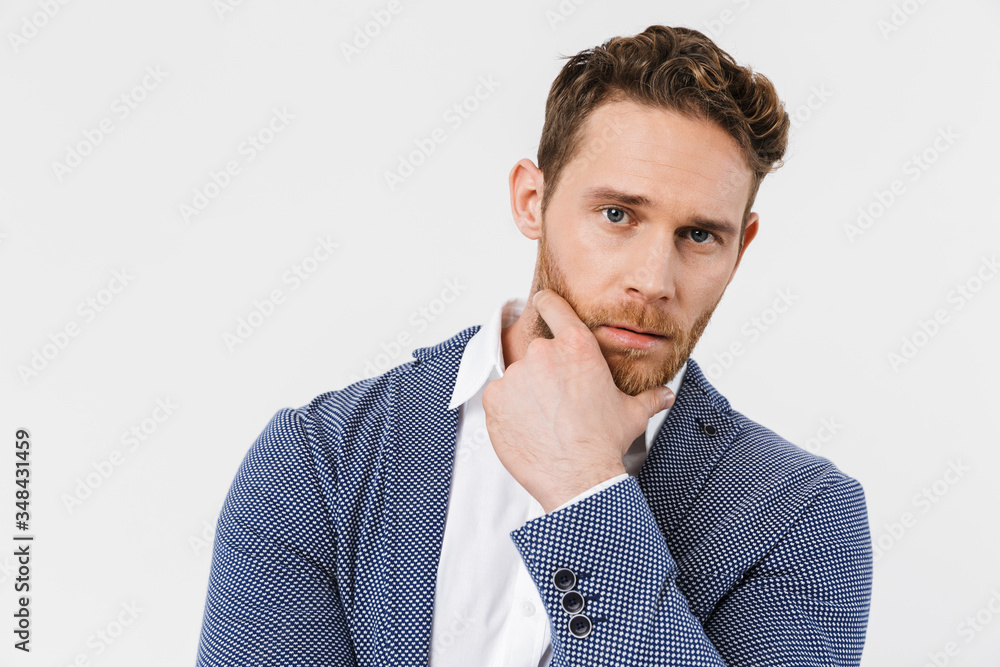 Image of confident young man posing and looking at camera Image of confident young man posing and looking at camera