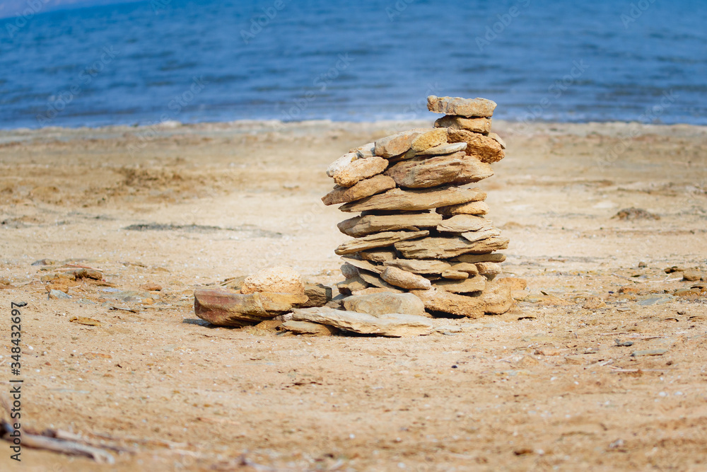 The yellow stone lies on the beach. The yellow stone lies on the beach.